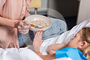 cropped image of sick kid rejecting food