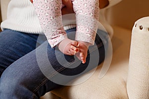 Cropped image of small baby feet and toes