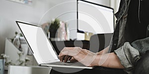 Cropped image of smart man`s hands typing on white blank screen computer laptop .