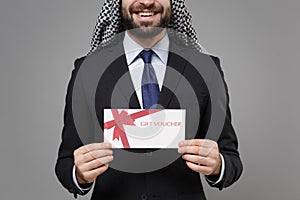 Cropped image of smiling bearded arabian muslim businessman in keffiyeh kafiya ring igal agal black suit isolated on