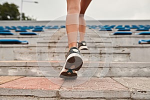 Cropped image of sports woman running on stairs