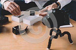 cropped image of technology blogger holding new smart watch in front