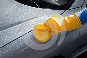 Cropped image of woman cleaning her car