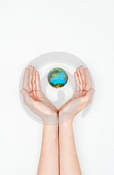 cropped image of woman holding hands around earth model