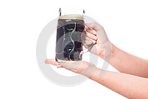 cropped image of woman holding mug of dark beer