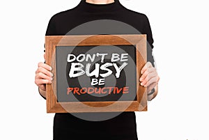 Cropped image of woman holding wooden board with inscription dont be busy be productive