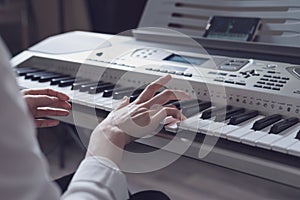 Cropped image of a woman learning to play the synthesizer using the application in the smartphone