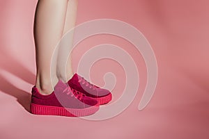 cropped image of woman legs in stylish sneakers