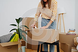 Cropped image of a woman packing, she`s moving out from old apartment