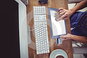 Cropped image of woman using tablet