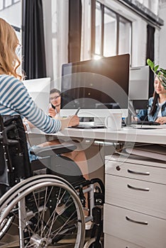 cropped image of woman in wheelchair using graphics tablet photo