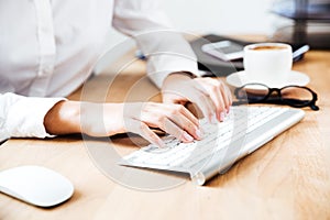 Cropped image of women`s hands typing on keyboard