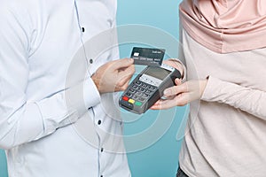 Cropped image of young arabian muslim man wonam in casual clothes isolated on blue background. People religious concept