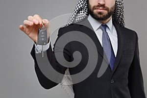 Cropped image of young bearded arabian muslim businessman in keffiyeh kafiya ring igal agal classic black suit 