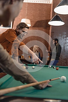 cropped image of young multiethnic friends playing in pool