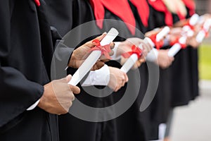 Cropped of international group of graduates holding diplomas