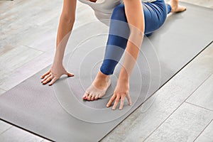 cropped legs of sportive mom-to-be stretching legs during workout at home