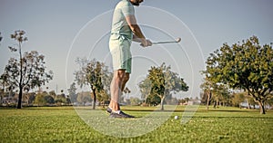 cropped male golf player on professional course with green grass, golf