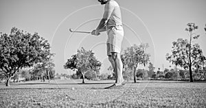 cropped male golf player on professional course with green grass, golf