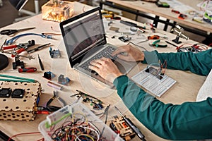 Cropped male programmer programm code of microchip