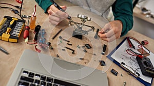 Cropped male technician or engineer soldering chip