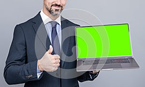 cropped man showing green screen. modern wireless laptop. thumb up. webinar pc advertisement.