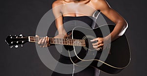 Cropped photo of African American woman playing guitar