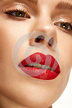 Cropped photo of beautiful woman with bright fashion make-up. Red lip matte lipstick. Female full plump sexy lips.