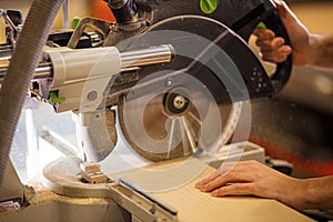 Cropped photo of carpenter using circular saw