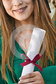 Cropped photo of College Graduate Holding Diploma