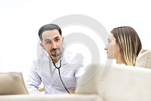 Cropped photo of doctor with stethoscope going to exam the pregnant woman.