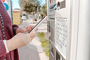 Woman paying for fuel via the smartphone