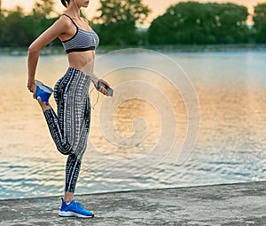 Cropped photo of girl making exercises on fresh air.