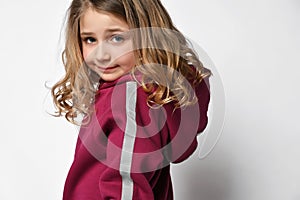 cropped photo of a girl in a warm burgundy hooded hoodie and a stripe of reflective tape on the sleeves