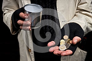 cropped photo of homeless male's hands holding money in hands