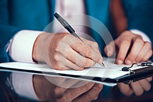Cropped Photo of Man in Suit Putting Signature.