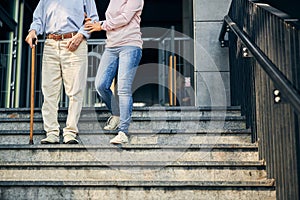 Cropped photo of old male person going down the stairs