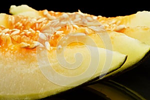 Cropped photo Piel de sapo pieces green melon isolated black photo