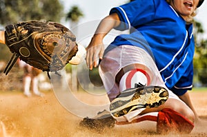 Cropped photo of softball player sliding into home plate
