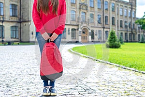 Cropped photo of teen standing near university ready for new year holding satchel in hands wearing denim outfit