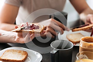 Cropped photo of woman put jam on bread