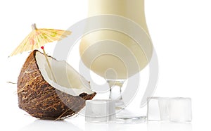 Cropped Pina colada cocktail with coconut and ice cubes isolated on white