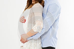 Cropped portrait of beautiful pregnant woman and her handsome husband hugging the tummy.Love concept. Happy event,birth of a child