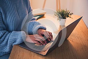 Cropped portrait of pretty young lady wear sweater arms typing laptop desk home office indoors