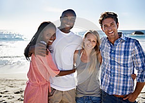 Double beach date. Cropped portrait of two happy couples enjoying a day at the beach.