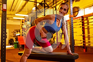 Cropped portrait of young sportive woman in colorful uniform training, pumping hands with dumbbells in gym