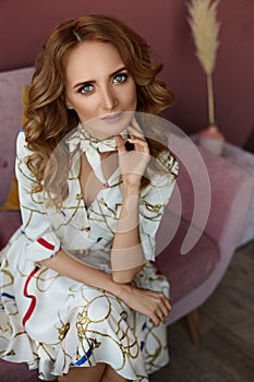 Cropped portrait of young woman with blue eyes and tender makeup in a summer dress. Concept of summer fashion