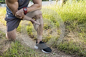 Cropped shot of an athletic man having calf muscle cramps. Endurance issues during outdoor run photo