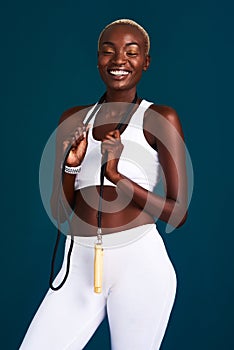 Staying fit keeps me happy. Cropped shot of an attractive young sportswoman standing alone and posing with a jump rope