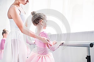 cropped shot of ballet teacher exercising with kids